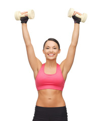 young sporty woman with light dumbbells