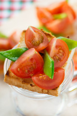 Bruschetta with fresh tomato and snow peas