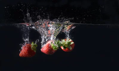 Kussenhoes Drie aardbeien plons op zwarte achtergrond © Diego Barbieri