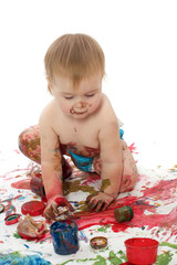 The kid plays with paints a white background