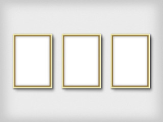 Three empty frames on a wall