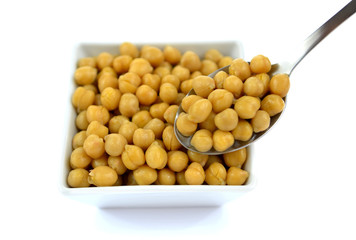 Chickpeas in small white dish with spoon