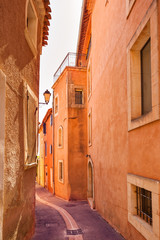 Roussillon village, urban street and red facades. Provence