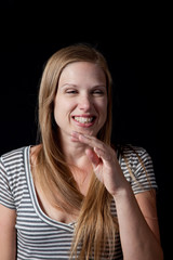 Blond in stripped dress, smiling at the camera