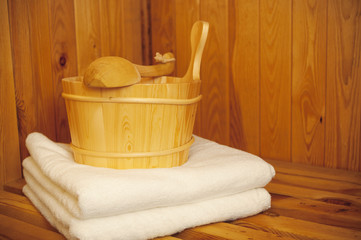 Obraz na płótnie Canvas Sauna - Bucket, ladle and towel in sauna