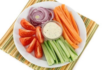 Assorted raw vegetables sticks in plate close up