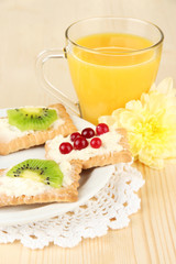 Tasty canapes with cheese and kiwi, cranberry,