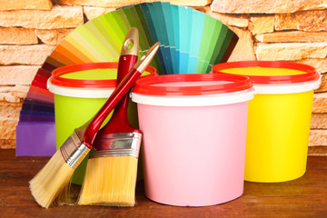 Fototapeta na wymiar Set for painting: paint pots, brushes, palette of colors