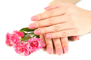 Woman hands with pink manicure and flowers, isolated on white