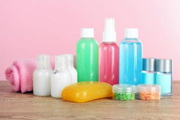 Hotel amenities kit on table on pink background