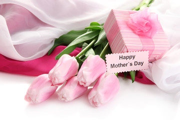 Bouquet of pink tulips and gift