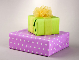Bright gifts with bows on grey background