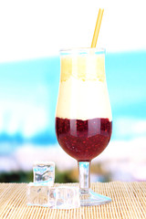 Delicious fruit smoothie on table on blue background