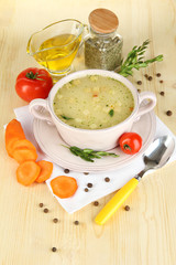 Nourishing soup in pink pan with ingredients