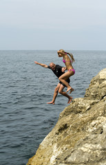 boy and girl jumping into the water