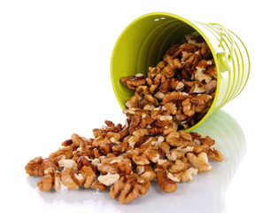 Overturned bucket with nuts isolated on white