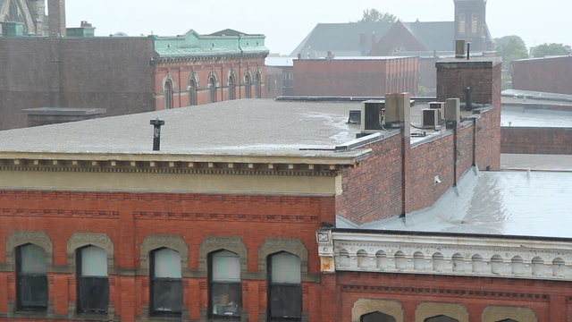 Heavy rain falling on buildings. Saint John, NB.