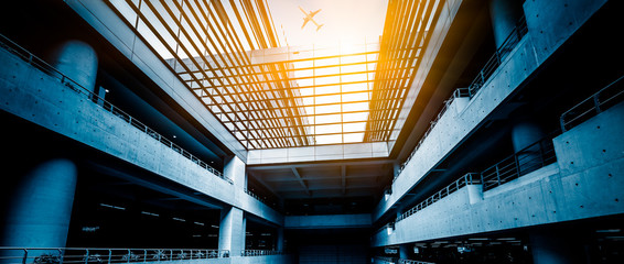airplane fly above the airport building