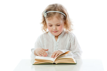 Small and beautiful girl reading a book