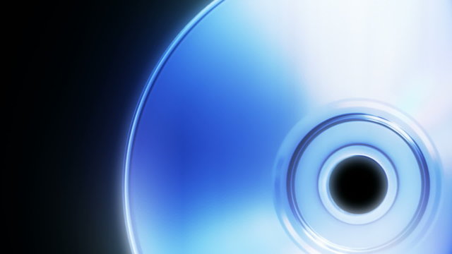 Compact disc on a black background close up (seamless loop)