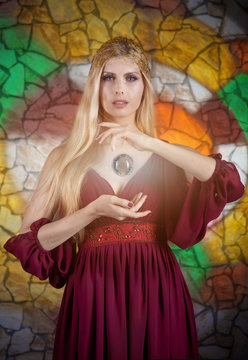 Woman in medieval dress with the "magic sphere"