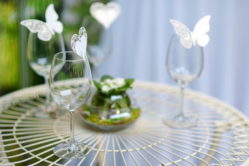Some wine glasses decorated with butterflies