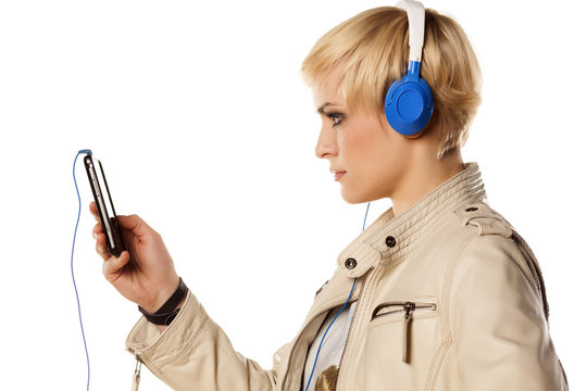 blonde girl, downloading music on her phone