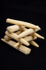 Baby corn on black background © bubu45