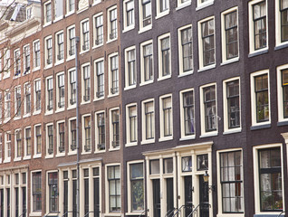 Fototapeta na wymiar View at typical Dutch houses in Amsterdam, The Netherlands