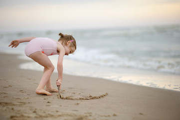 Little girl on a sand beach