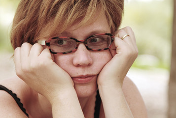 Close up portrait of sad redheaded woman