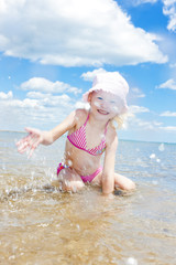 little girl on the beach at sea