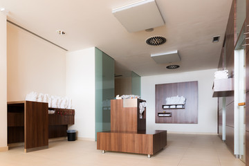 bathrobes and towels in wellness area with wooden shelfs