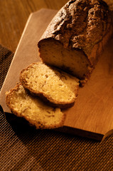 warm tone shot of sliced bread on wood cutting plate