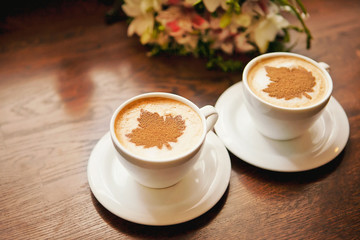 Cups of coffee on a wooden table