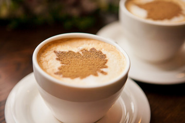 Cups of coffee on a wooden table