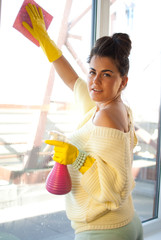 Young woman clean windows