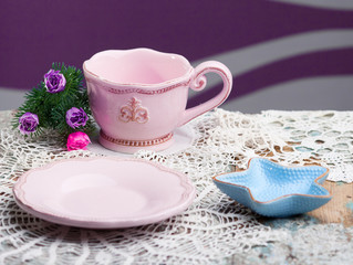 dishes on wooden table with crochet doily