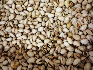 Many shelled pistachios as background