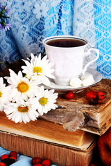 Gentle autumn still life with books and cup of tea close-up