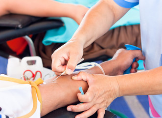 arm of a donor donating blood at hemotransfusion station