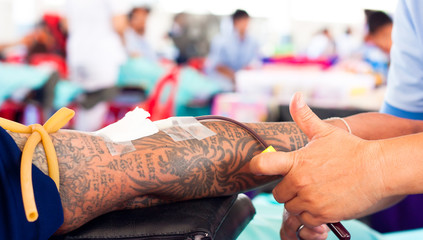 arm of a donor donating blood at hemotransfusion station