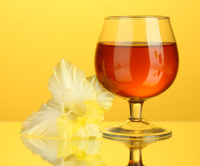 glass with cocktail and gladiolus bud