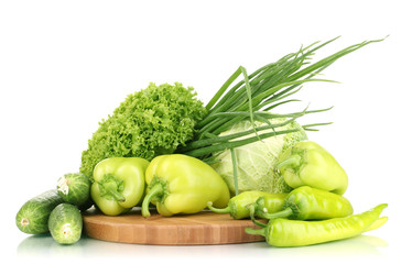 fresh green vegetables on chopping board isolated on white
