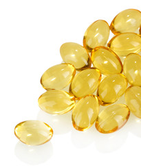 pellets of fish oil on white background close-up
