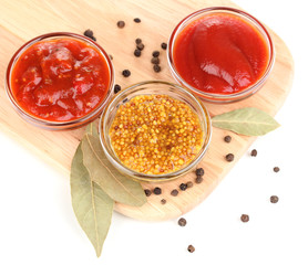 various sauces on chopping board isolated on white © Africa Studio