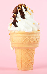Tasty ice cream with chocolate, on pink background