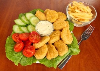 Fried chicken nuggets with vegetables,french fries and sauce