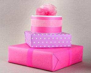 Bright gifts with bows on grey background