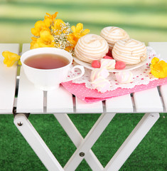 Beautiful composition with cup of tea and marshmallow